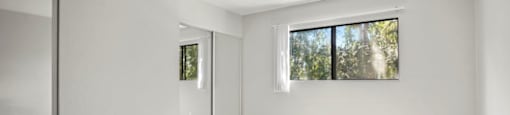 Brody Terrace Bedroom with Mirrored Closet Doors and Carpet