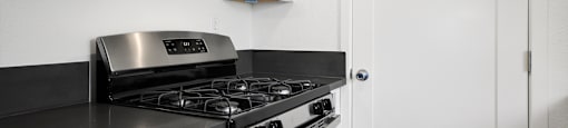 Kitchen with Stainless Steel Appliances in Sherman Oak Apartment