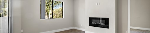 A room with a fireplace and a window.