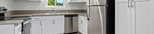 Apartments for Rent in Sherman Oaks - Krystal Terrace - Kitchen with Stainless-Steel Appliances, Natural Lighting, and White Cabinets