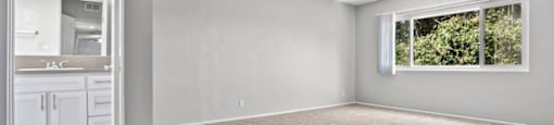 One-Bedroom Apartments in Sherman Oaks, CA - Krystal Terrace - Bedroom with Plush Carpeting, Natural Lighting, and Bathroom Access