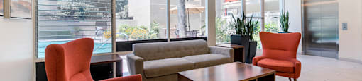 Sherman Oaks Apartments - Krystal Terrace Apartments Lobby with Table, Cozy Seating, and Modern Decor