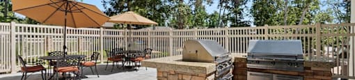 Outdoor BBQ Area with Multiple Grills and Shaded Table Seating at The Meadows at Westlake Village Apartments,California, 91361