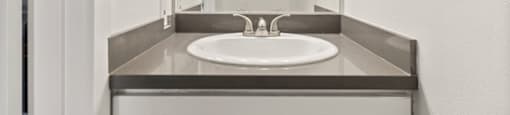 a bathroom with a sink and a mirror at Parkway Plaza Apartments, Culver City, 90230