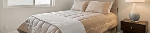 a bedroom with a bed and a ceiling fan at Parkway Plaza Apartments, California, 90230