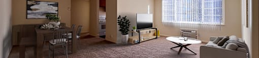 a living room with a big window, couch, table, and tv on tv stand and a dining room with table and chairs and a ceiling fan at Huntington Green Apartments, Ohio