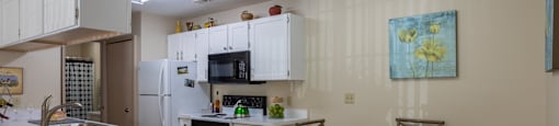 A kitchen with a table and chairs. at Highlands of Heritage Woods Apartments, Ohio, 44321