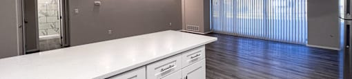 an empty kitchen with white counter tops and stainless steel appliances at Huntington Green Apartments, Ohio