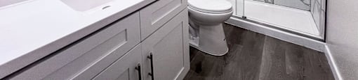 a bathroom with a shower and a sink and a toilet at Huntington Green Apartments, University Heights, 44118