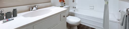 a bathroom with a shower, toilet, and a sink at Huntington Green Apartments, University Heights, OH
