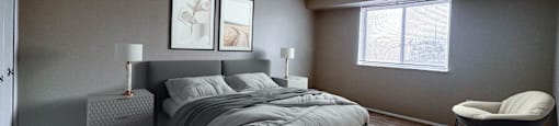 Bedroom with a bed, area rug, dresser, and chair at Huntington Green Apartments, University Heights, Ohio
