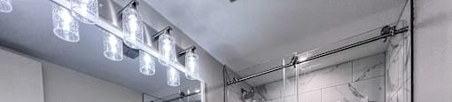 a bathroom with a shower and a sink and a toilet at Huntington Green Apartments, University Heights, 44118