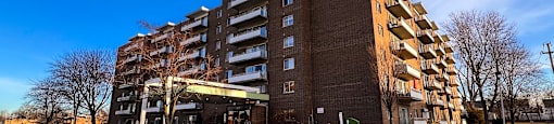 a large apartment building on the corner of a street at Huntington Green Apartments, University Heights, Ohio