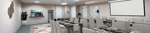 sample setup of the party room with tables and chairs and a projection screen at Huntington Green Apartments, University Heights, 44118