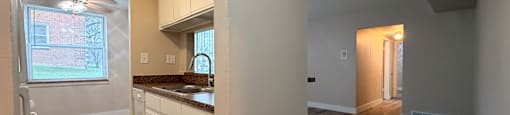 A kitchen with wooden floors and white walls.