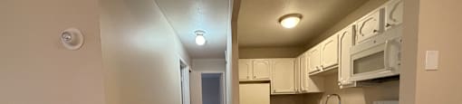 A kitchen with white cabinets and appliances.