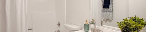 a bathroom with a sink toilet and shower at Ascent on Peoria Apartments, Phoenix