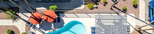 an aerial view of a building with a blue pool in the middle of it