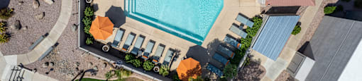 arial view of a swimming pool in a backyard with umbrellas at Paseo 51 Apartments, Glendale, Arizona