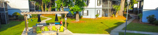a backyard with a picnic table and a swing at Planters Trace Apartment Homes, Charleston, South Carolina