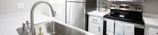 a kitchen with a sink stove refrigerator and microwave at Ascent on Peoria Apartments, Phoenix, AZ