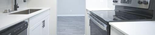 an empty kitchen with white cabinets and stainless steel appliances at Planters Trace Apartment Homes, Charleston, SC 29414