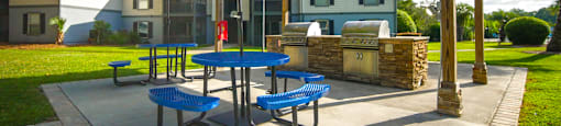 a patio with a picnic table and an umbrella