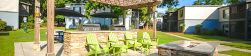 a patio with a fire pit and a pergola at Planters Trace Apartment Homes, Charleston, SC