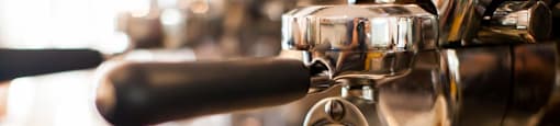 A coffee machine is dispensing coffee into a white cup at Ascent on Spence, Tempe, AZ 85281