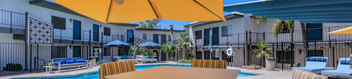 Apartment rental community outdoor seating near swimming pool at Ascent 1829