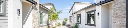 Landscaped walkways between the apartment homes at Village Greens of Queen Creek