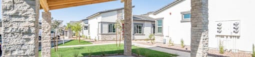 Shaded outdoor lounge area at Village Greens of Queen Creek
