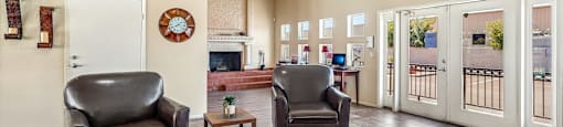 A living room with two chairs and a table.