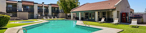 A swimming pool in a backyard with a house in the background.