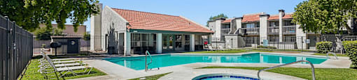 A swimming pool with a small round pool in the middle.
