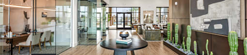 A modern dining room with a glass table and chairs.