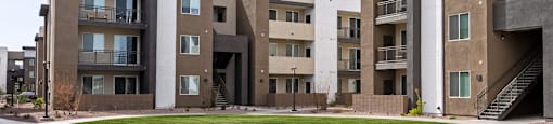 Apartment complex with a green lawn in front.