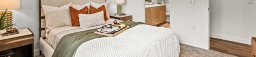 A bedroom with a bed, nightstand, and a ceiling fan.