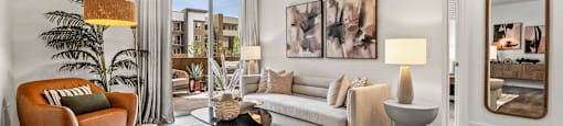 A living room with a brown chair and a white couch.