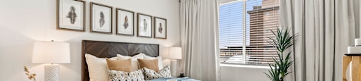A bedroom with a bed, nightstand, and a ceiling fan.