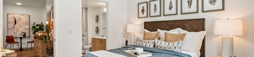 A bedroom with a bed, nightstand, and a ceiling fan.