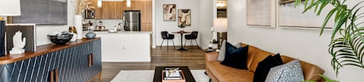 A living room with a brown couch and a ceiling fan.
