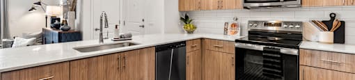 A modern kitchen with wooden cabinets and stainless steel appliances.