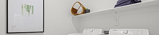 A small laundry room with a washer and dryer.