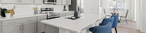 A modern kitchen with a dining area.