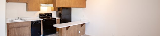 Kitchen and living room at La Lomita Apartments in Tucson Arizona