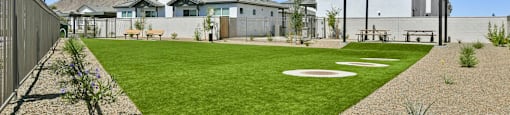 A house with a white fence and a green lawn.