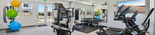 A spacious gym with a variety of exercise equipment and a balloon sculpture.