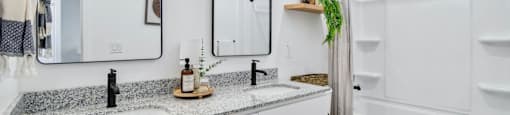 A bathroom with a white toilet, sink, and bathtub.