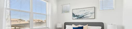 A bedroom with a large bed and a ceiling fan.
